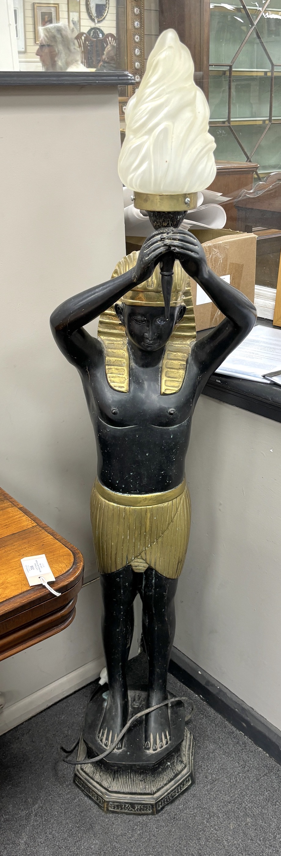 A pair of Egyptian Art Deco style painted metal floor lamps with opaque flambé shades, height 142cm